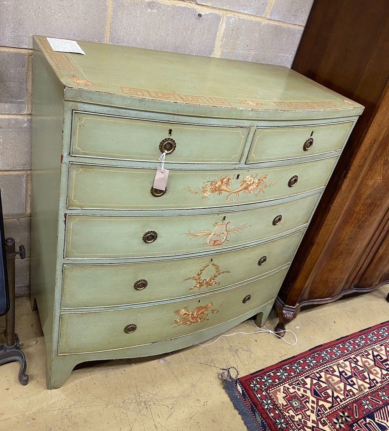 A Regency style painted bow front chest, width 107cm, depth 54cm, height 120cm